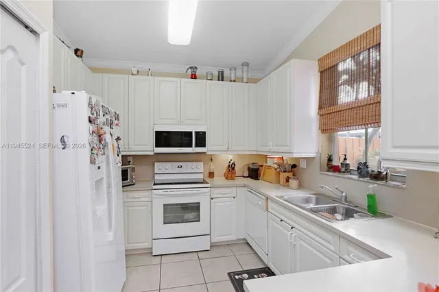 a kitchen with stainless steel appliances a refrigerator sink and cabinets