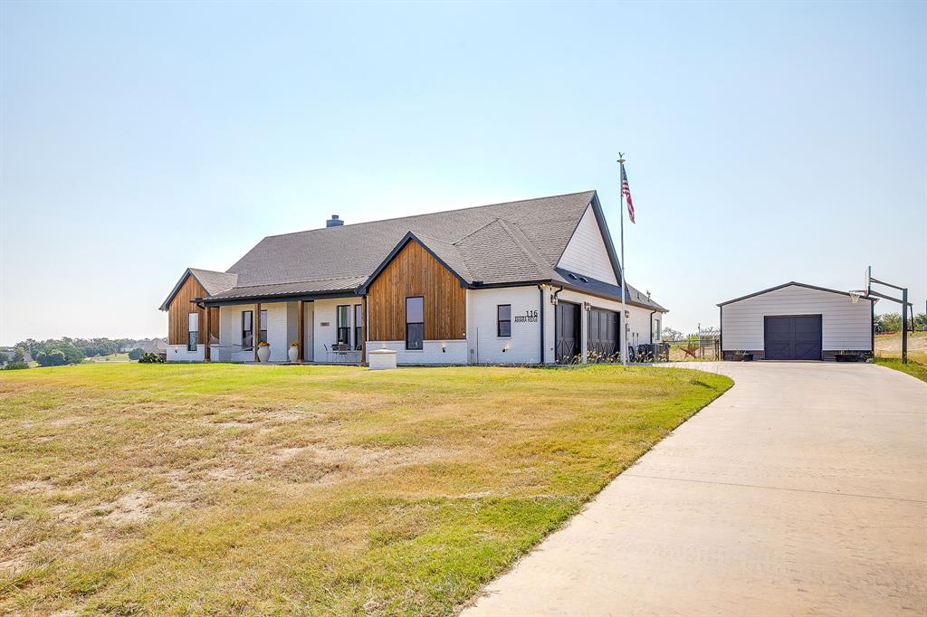 116 Aviara Ridge Road Poolville, TX 76487 - Photo 6 of 38 a front view of a house with a big yard