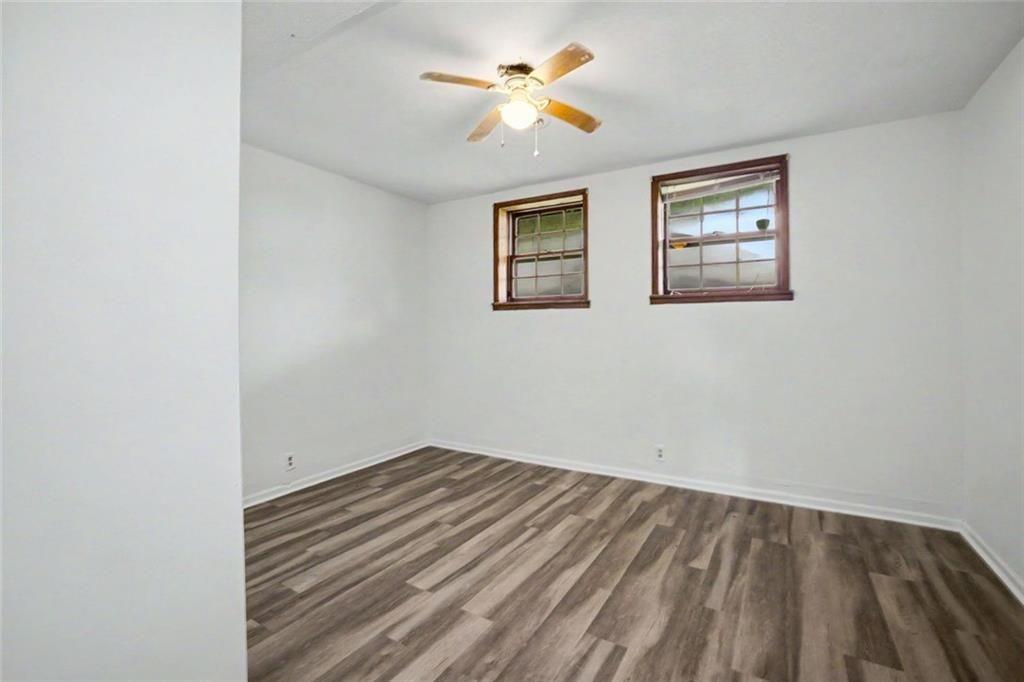 1605 Shackelford Road Griffin, GA 30224 - Photo 33 of 51 an empty room with a window and a ceiling fan