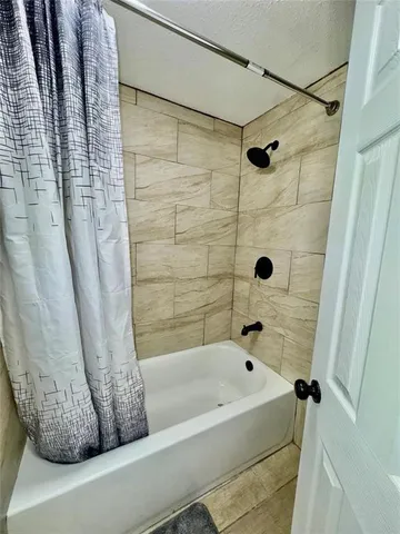 a bathroom with a bathtub and shower