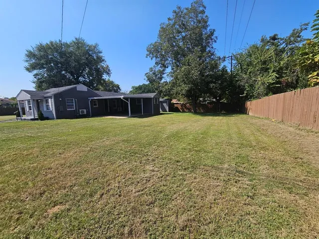 a view of a house with a yard and garage