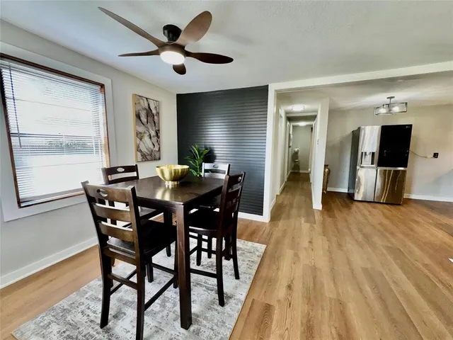 a dining room with furniture and window