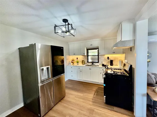 a kitchen view with stainless steel appliances a stove refrigerator and microwave