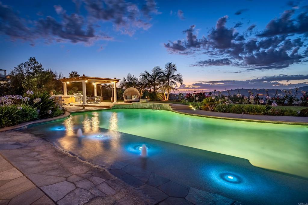 8122 Twilight Point Way San Diego, CA 92127 - Photo 1 of 50 a view of a swimming pool with an outdoor space and seating area