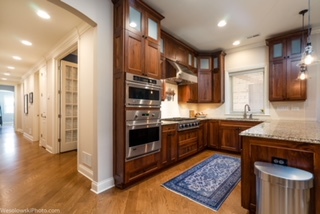 106 South Sangamon Street, Unit 2N Chicago, IL 60607 - Photo 7 of 27 a kitchen with stainless steel appliances granite countertop a refrigerator a sink dishwasher and a stove with wooden floor