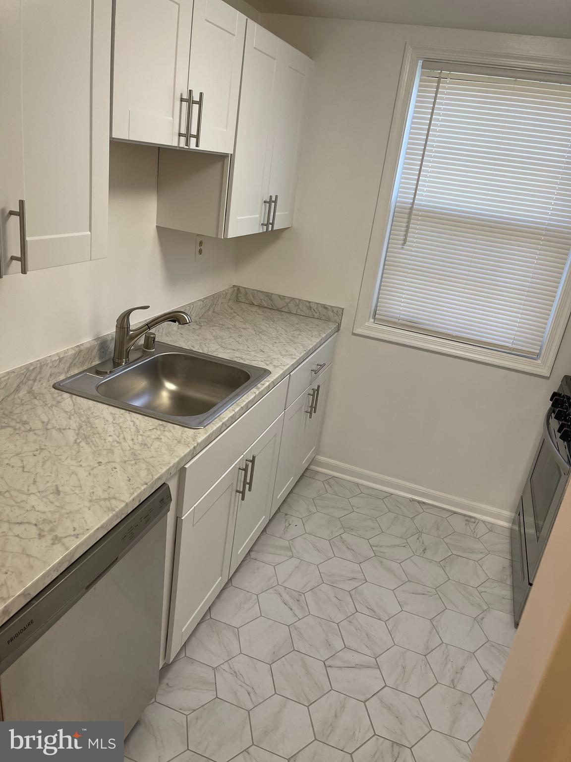 4370 North Pershing Drive, Unit 2 Arlington, VA 22203 - Photo 6 of 17 a kitchen that has a sink and a stove
