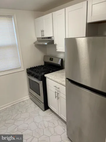 a kitchen with a stove and a refrigerator