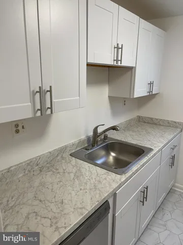 a kitchen with granite countertop a sink and a stove