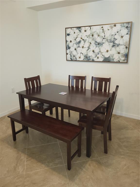 17108 Vardon Terrace, Unit 208 Lakewood Ranch, FL 34211 - Photo 14 of 14 a view of a dining room with furniture