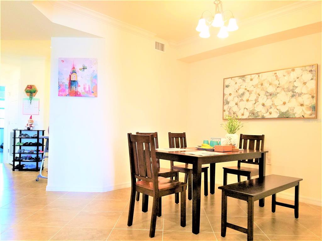 17108 Vardon Terrace, Unit 208 Lakewood Ranch, FL 34211 - Photo 2 of 14 a view of a dining room with furniture and wooden floor
