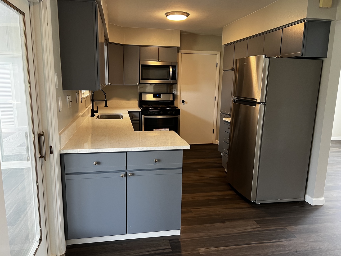 121 Wendell Place DeKalb, IL 60115 - Photo 12 of 35 a kitchen with a refrigerator and a sink