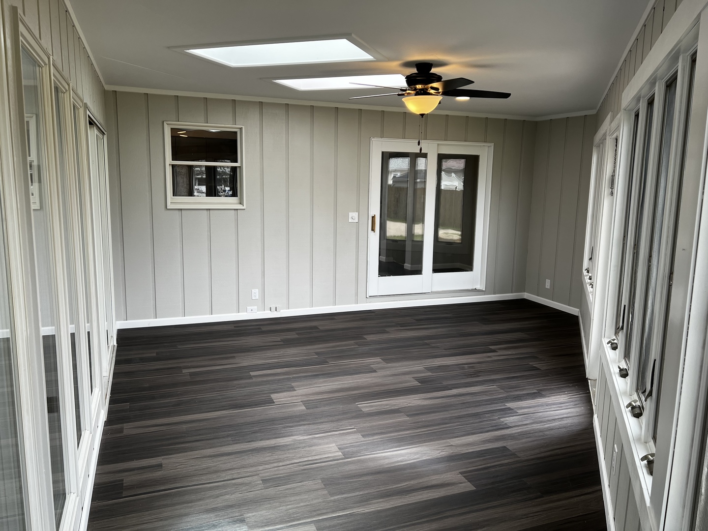 121 Wendell Place DeKalb, IL 60115 - Photo 18 of 35 a view of a livingroom with wooden floor and a ceiling fan