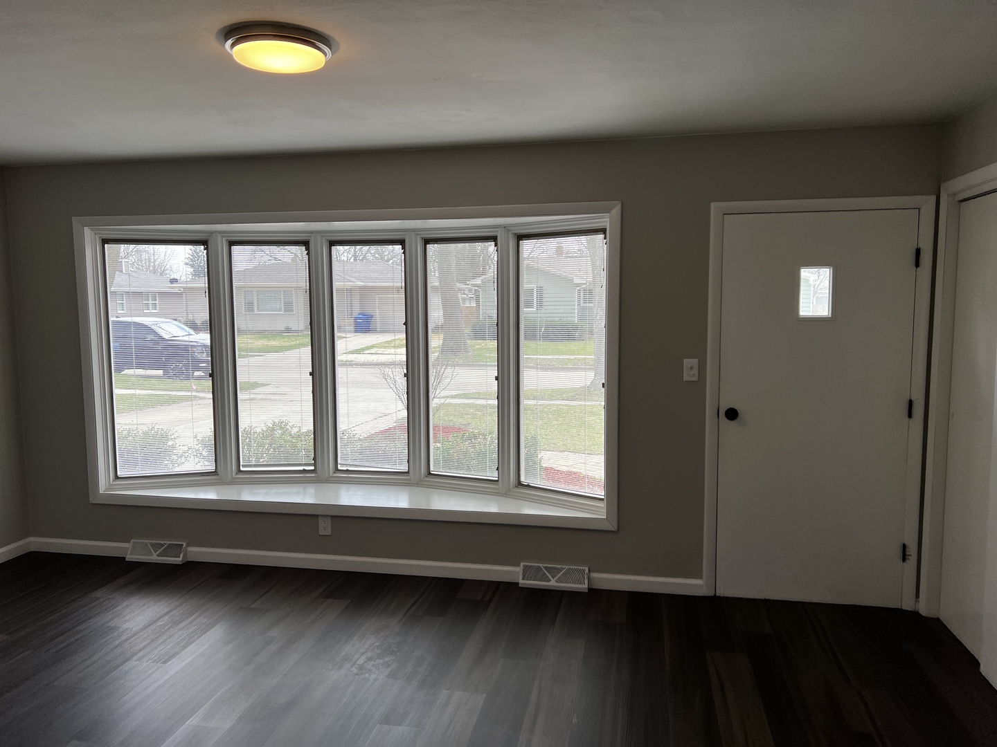 121 Wendell Place DeKalb, IL 60115 - Photo 9 of 35 a view of an empty room with wooden floor and a window