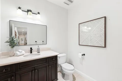 a spacious bedroom with a bed couch and a large window