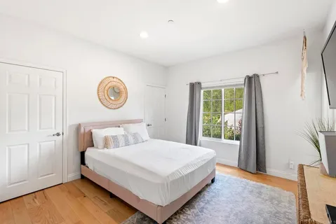 a bedroom with a bed and a window