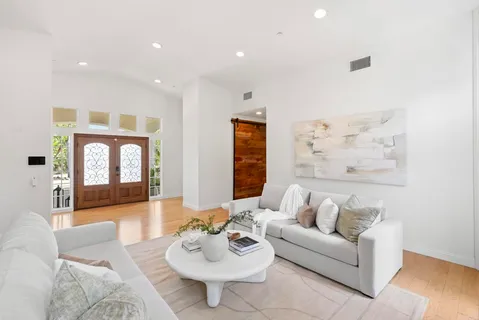 a open kitchen with stainless steel appliances granite countertop a stove refrigerator and a view of living room