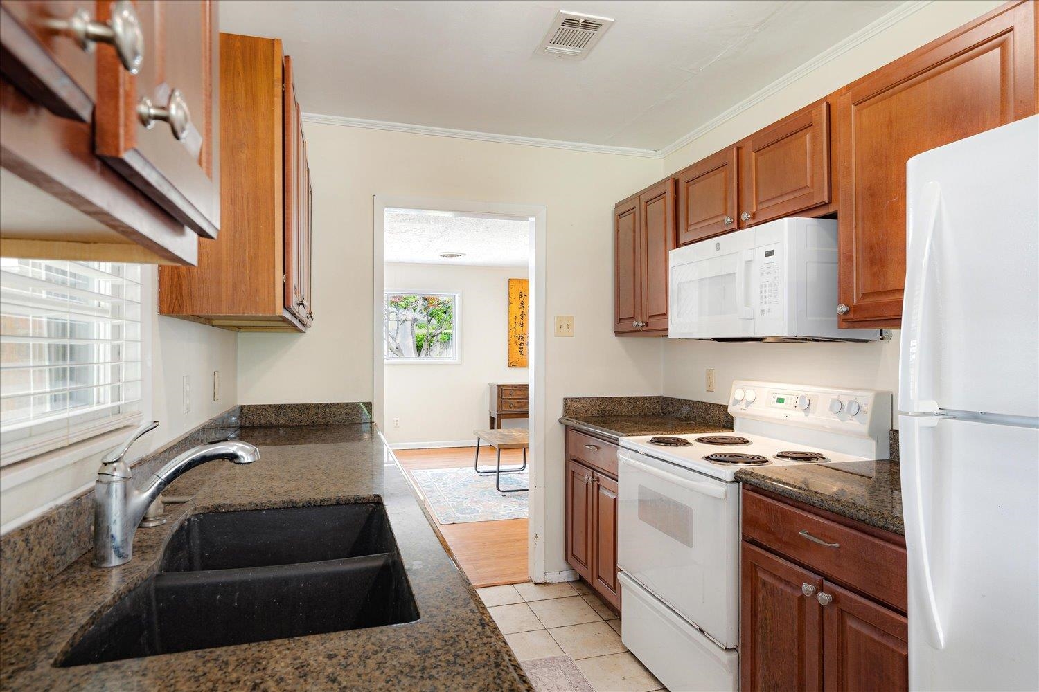 1524 Hopewell Road Memphis, TN 38117 - Photo 11 of 34 a kitchen with a stove a sink and a refrigerator
