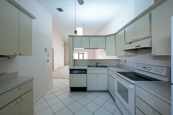 a kitchen with a stove sink and refrigerator