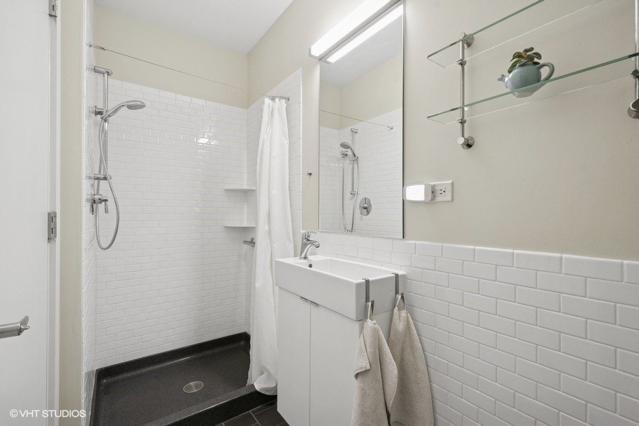 2206 Forestview Road Evanston, IL 60201 - Photo 13 of 32 a bathroom with a shower and a sink
