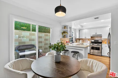 a kitchen with kitchen island granite countertop a table and chairs