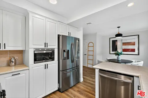 a kitchen with a refrigerator sink and microwave