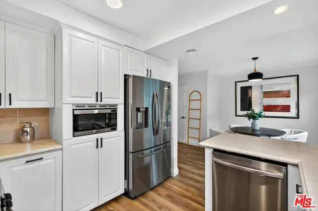 a kitchen with a refrigerator sink and microwave