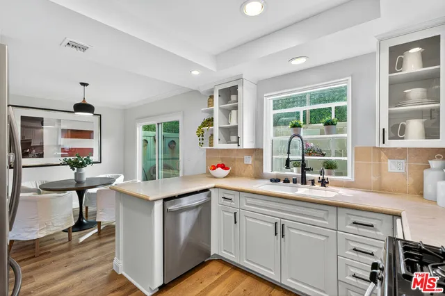 a kitchen with a sink stove and cabinets