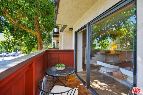 a view of balcony with a potted plant and outdoor seating