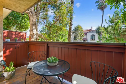 a view of a chairs and table in patio