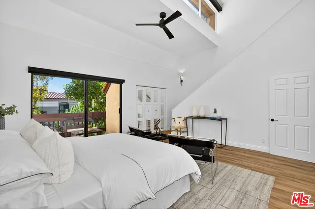 a bedroom with a large bed and a window