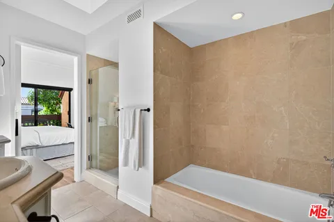 a bathroom with a bathtub and shower