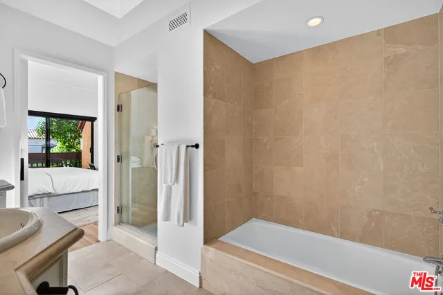 a bathroom with a bathtub and shower