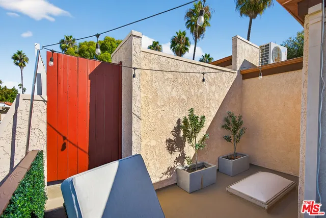 a bedroom with a bed and a lamp