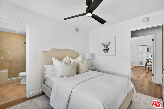 a bedroom with a bed and a large mirror