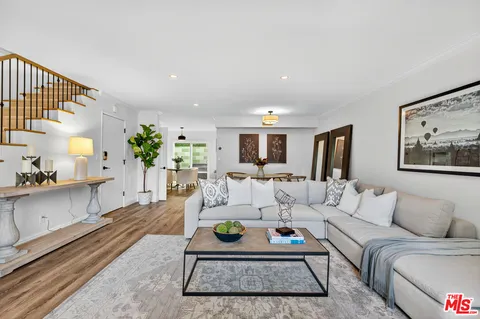 a living room with furniture and a rug