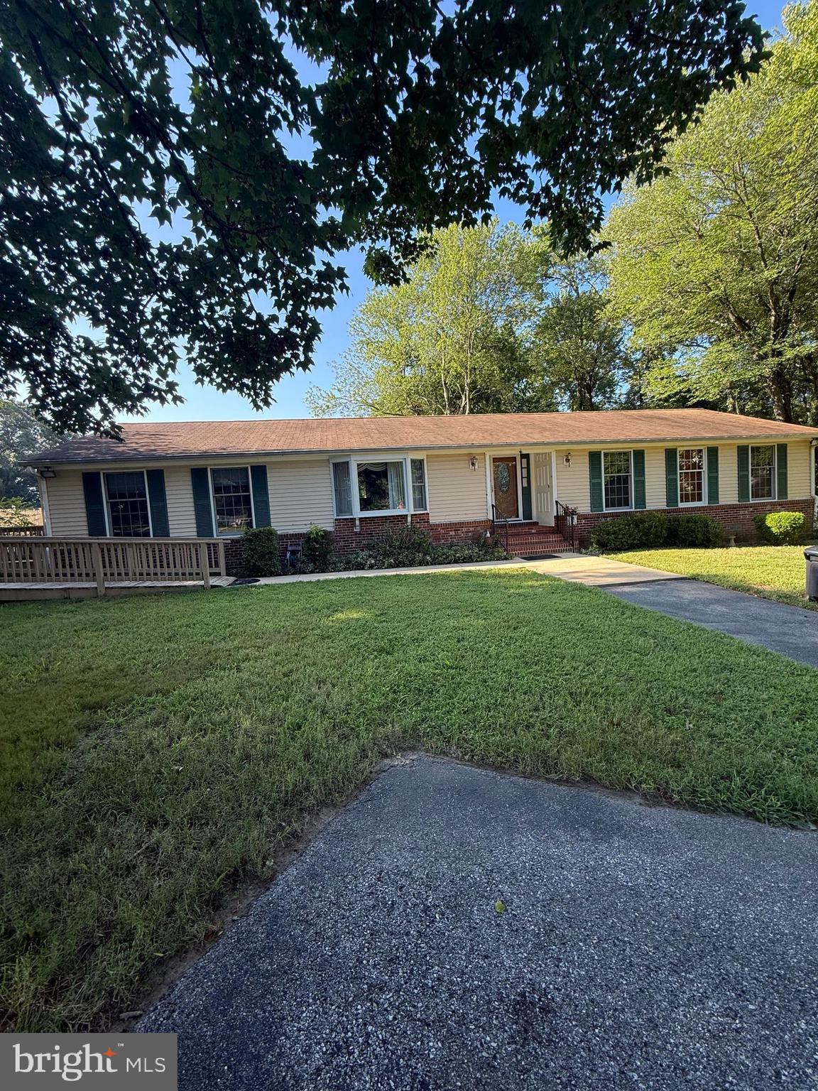 a view of a house with a yard and sitting area