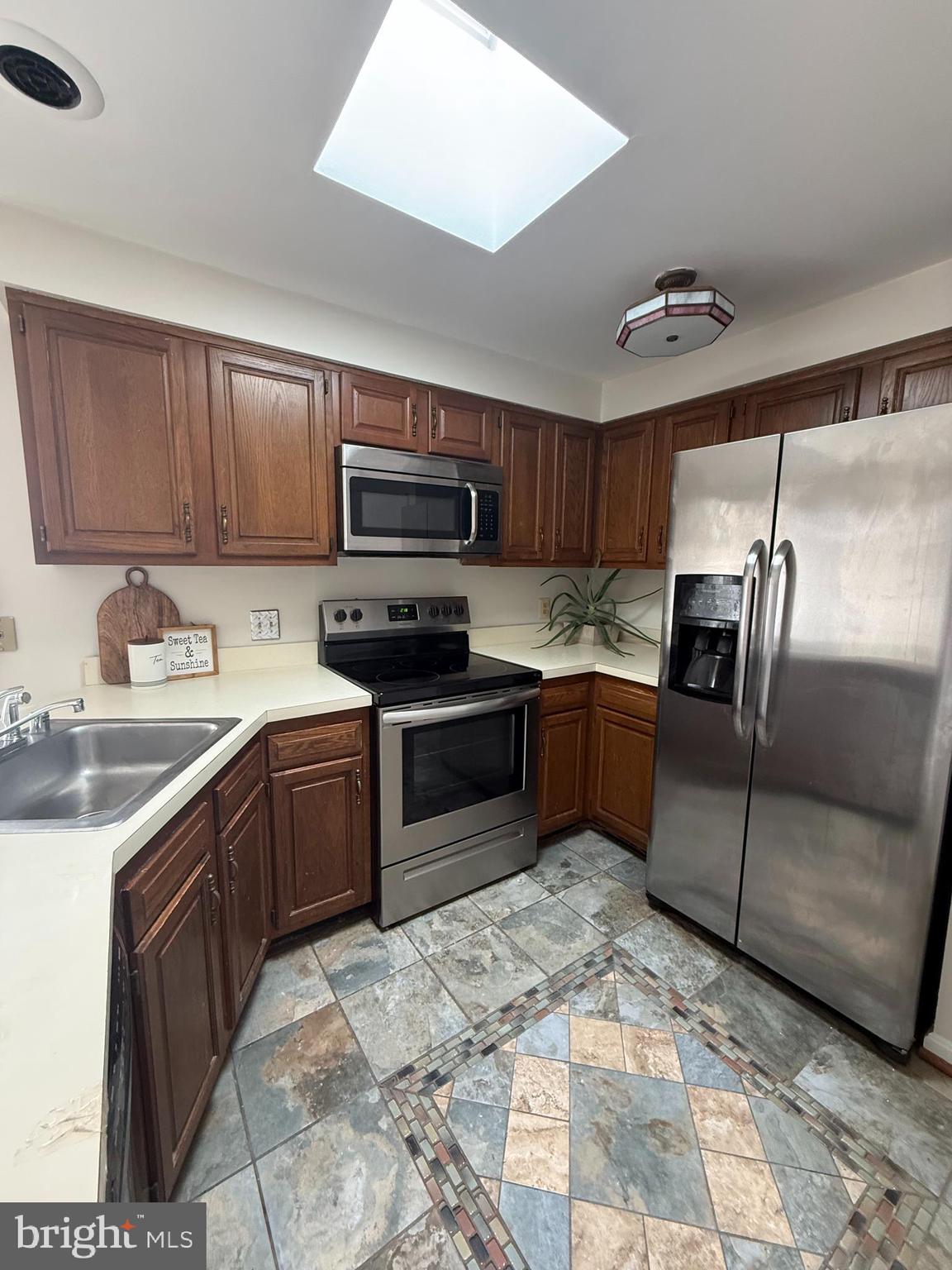 6608 Horseshoe Road Clinton, MD 20735 - Photo 13 of 20 a kitchen with stainless steel appliances granite countertop a sink stove and refrigerator