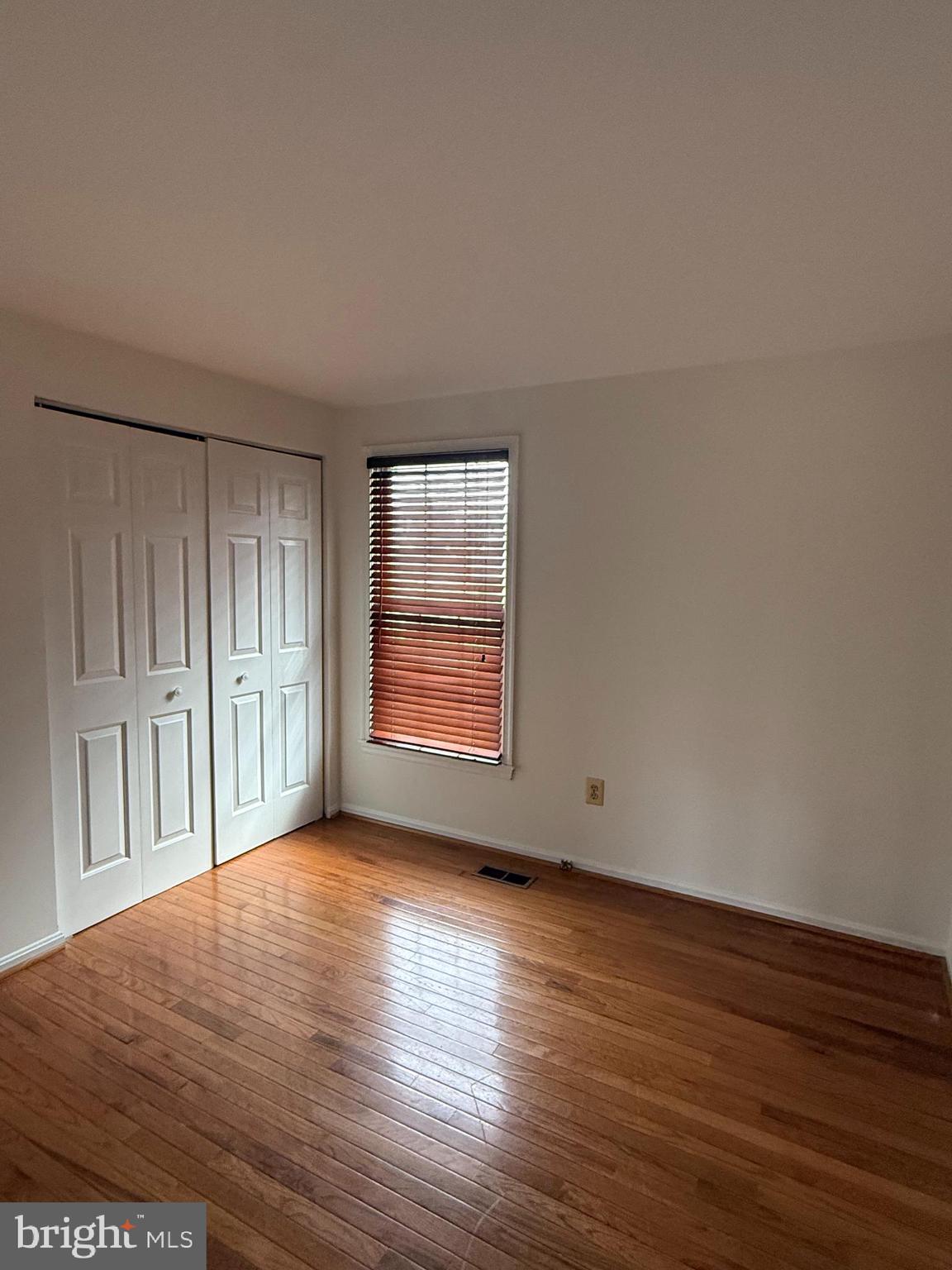 6608 Horseshoe Road Clinton, MD 20735 - Photo 18 of 20 a view of an empty room with wooden floor and a window
