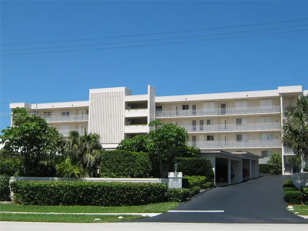 a view of a building with trees in front of it