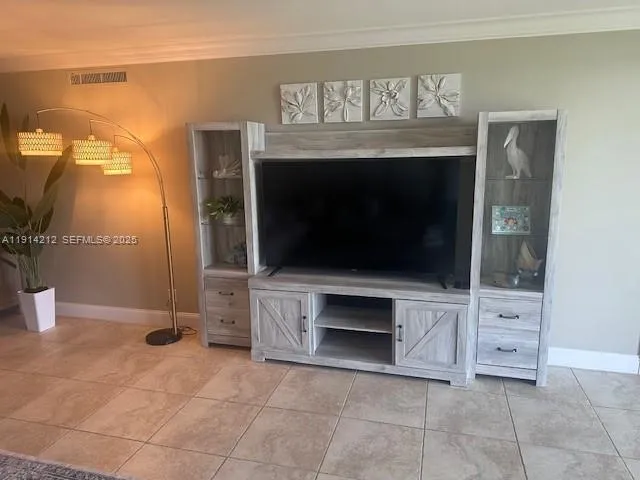 a living room with a fireplace and a flat screen tv