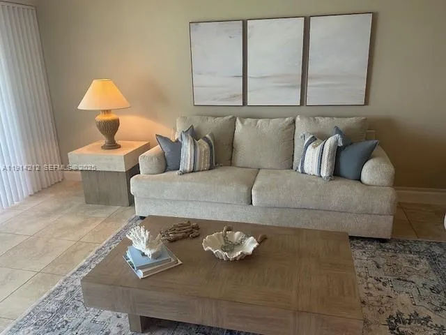 a living room with furniture and a lamp