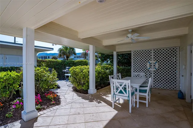 a view of a patio with table and chairs and potted plants