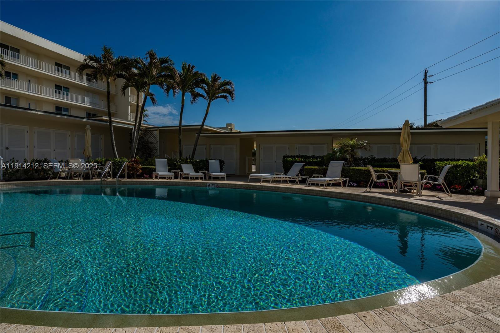 350 South Beach Road, Unit 204 Tequesta, FL 33469 - Photo 24 of 38 a view of a swimming pool with a yard