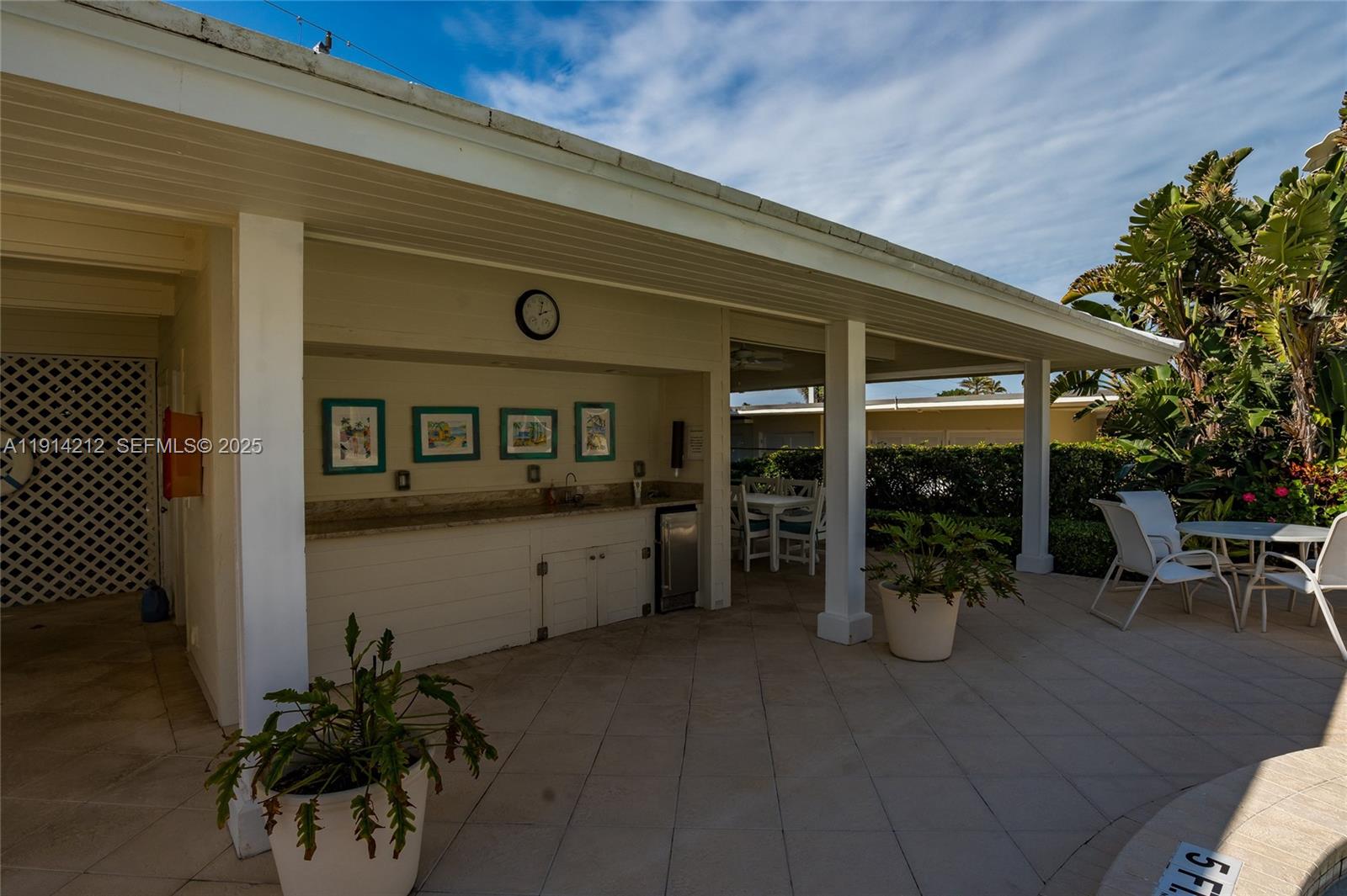 350 South Beach Road, Unit 204 Tequesta, FL 33469 - Photo 27 of 38 a view of a chairs and table in a patio