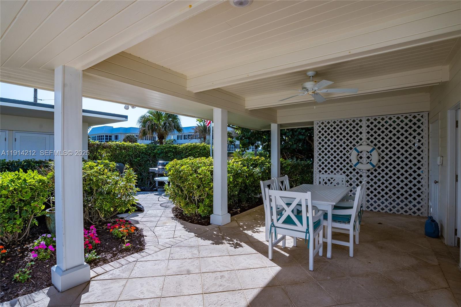 350 South Beach Road, Unit 204 Tequesta, FL 33469 - Photo 28 of 38 a view of a patio with table and chairs and potted plants
