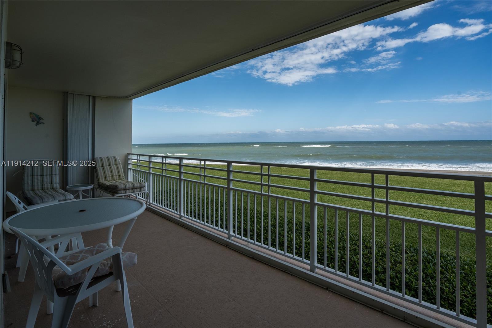 350 South Beach Road, Unit 204 Tequesta, FL 33469 - Photo 30 of 36 a view of a chairs and table in patio