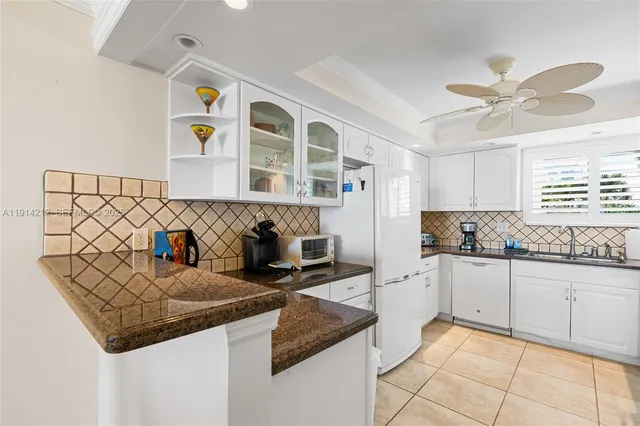 a kitchen with stainless steel appliances granite countertop a sink and cabinets