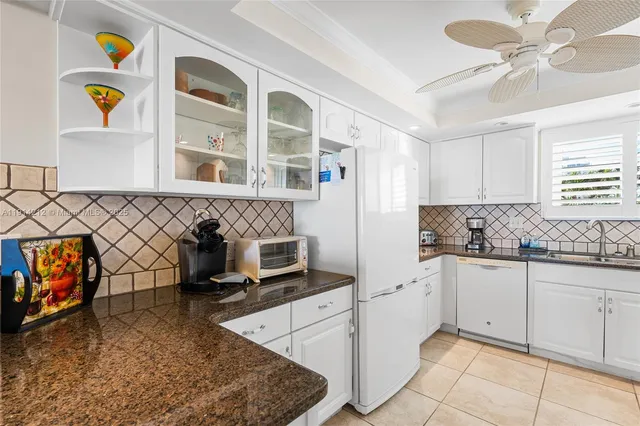 a kitchen with stainless steel appliances granite countertop a sink and a stove top oven