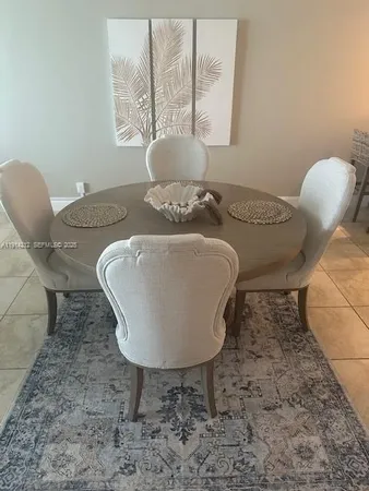 a table with vase and flowers on it
