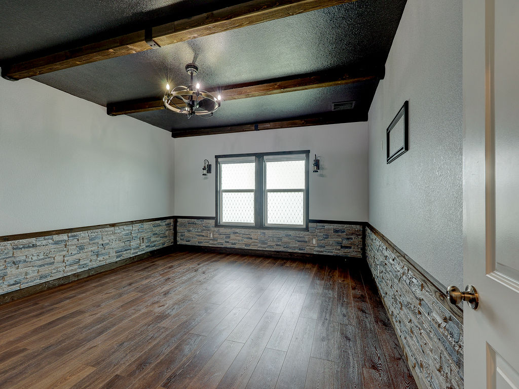 1716 Frontenac Street Leander, TX 78641 - Photo 16 of 34 a view of an empty room with wooden floor and a window